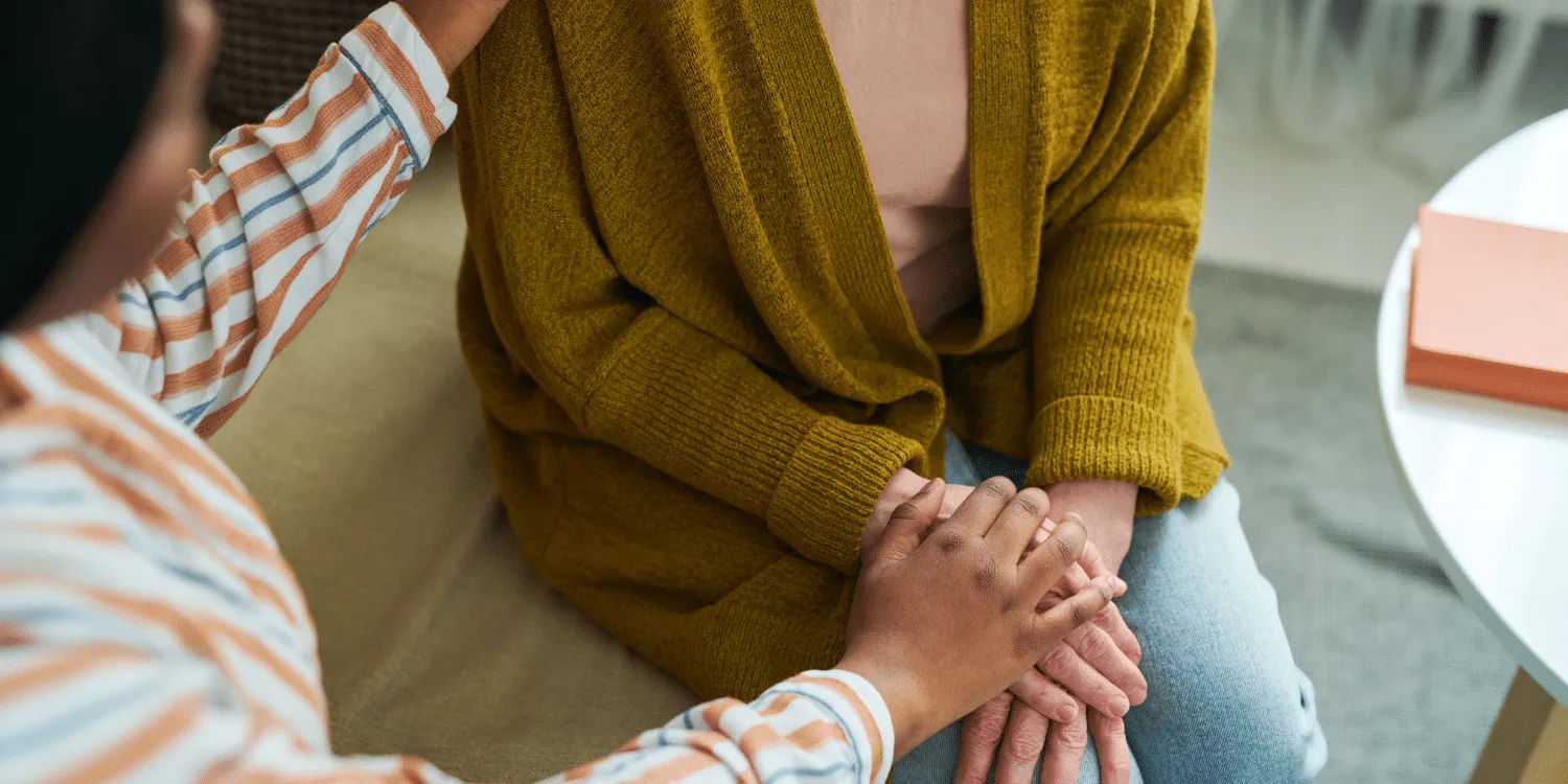Two women sitting on couch communicating - Community Support Worker vs Social Worker: A Comprehensive Guide for Career Seekers