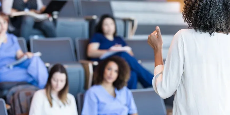Professor lecturing to medical students in lecture hall - 6 Career College Benefits for Immigrants in Calgary