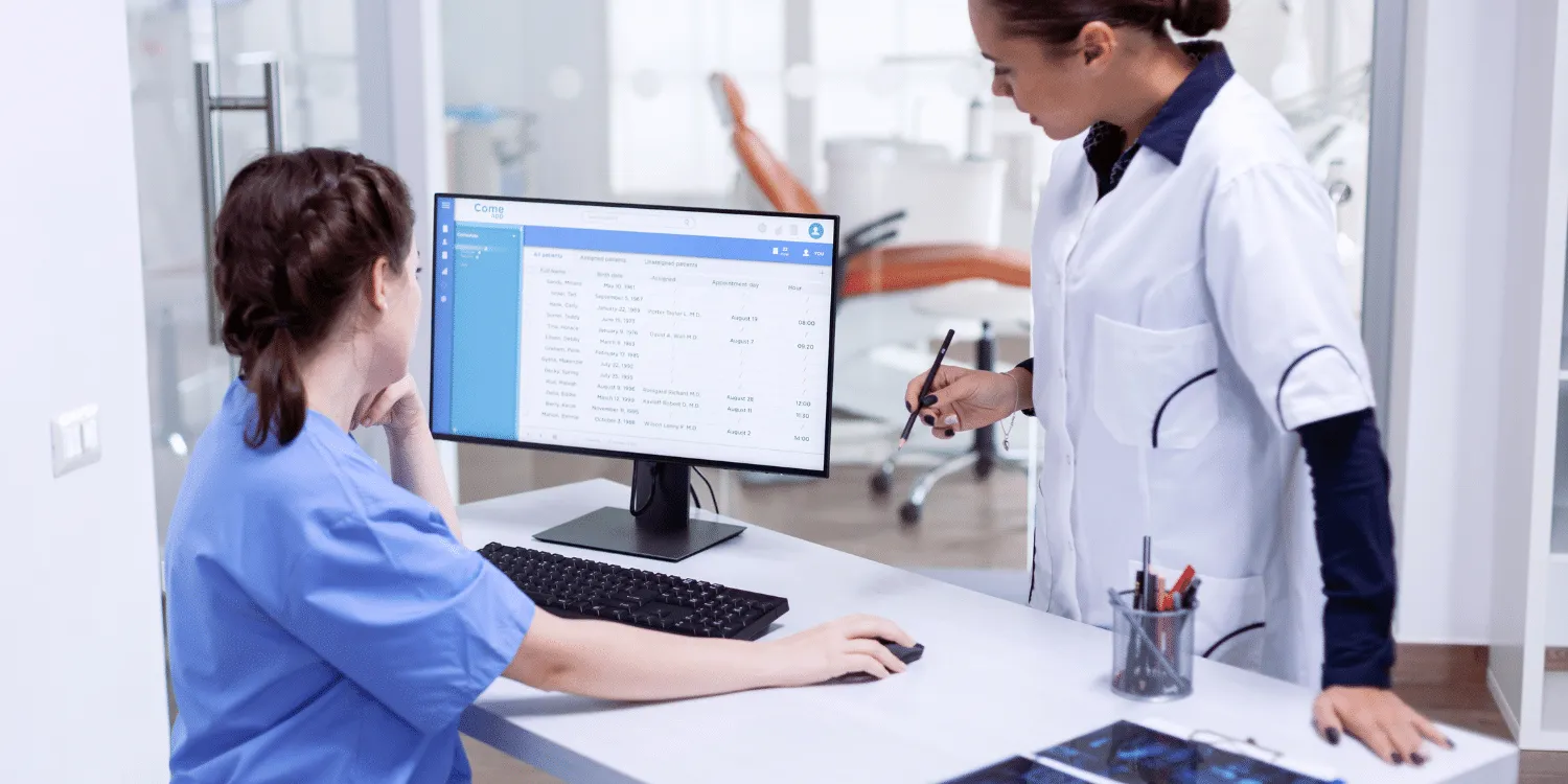 Dental office Admin speaking to Dentist - 10 Essential Answers to FAQs About Dental Office Administration in Alberta