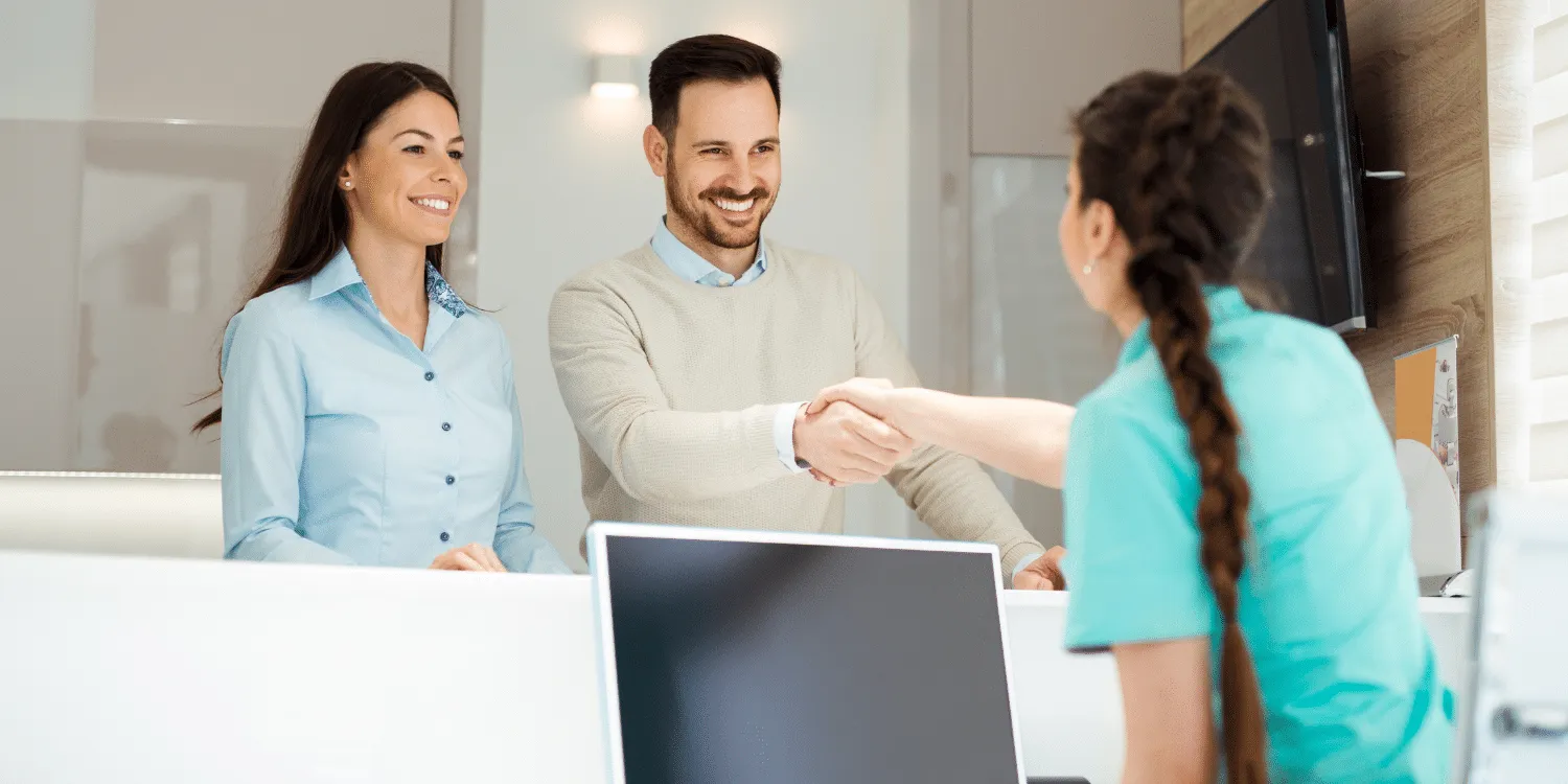 Dental Office Assistant with a couple of patients - Dental Assistant Vs. Dental Office Assistant in Alberta - Know the Difference